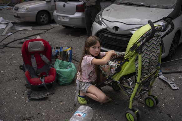 Polina, 10, looks after her sister Marina, 3, at the site of Okhmatdyt children’s hospital hit by Russian missiles, in Kyiv.