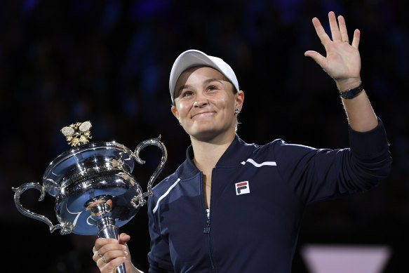 Barty of Australia waves as she holds the Daphne Akhurst Memorial Cup.