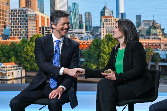 Lord Mayor Nick Reece and Greens mayoral candidate Roxane Ingleton shake hands before the debate. 