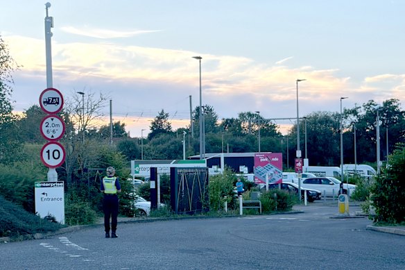 Police at Progress Park in Bedford, England, where families will pick up loved ones, after a train crash south of Bedford, England.