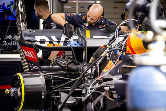 Red Bull Racing engineers work on the rear wing of Max Verstappen’s car to ensure it opens up to enable DRS, in Spain in 2022.