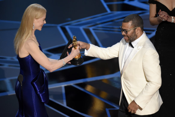 Nicole Kidman, left, presenting Jordan Peele with the award for best original screenplay for Get Out 