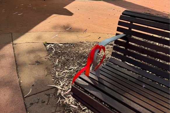 Red and orange ribbons tied to a bench in Monbulk, in Melbourne’s outer east, in memory of Bell.