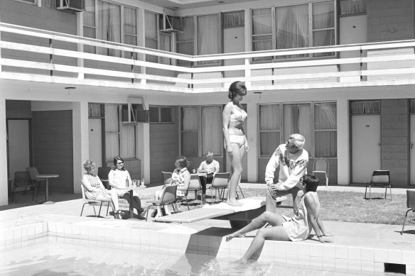 Alice Springs, 1970:  “A man kicks back in a freshly ironed pair of slacks, while a woman in a bikini wonders why he’s wearing a jumper,” notes Tim Ross.