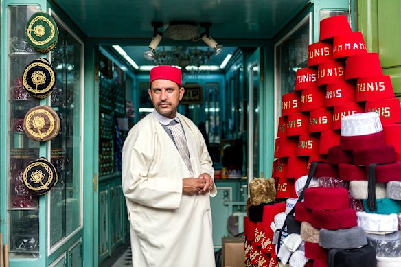 The red fez and a merchant at the Grand Souk.