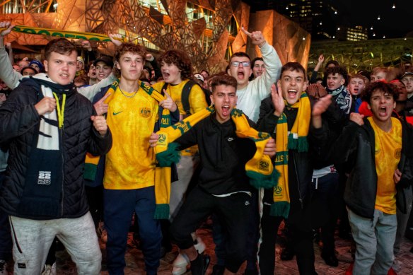 Socceroos fans go wild in Federation Square, Melbourne.