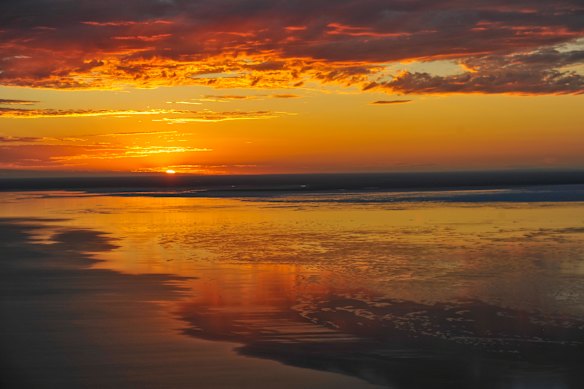 Floodwaters bring life and colour to outback sunsets.