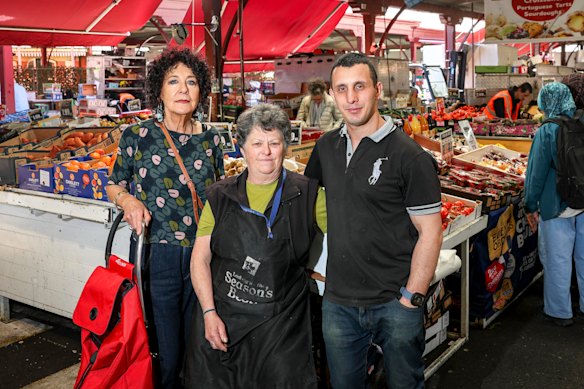 Mary-Lou Howie, left, president of Friends of Queen Victoria Market, Rosa Ansaldo and Franceso Fontana, both fruit stall owners at the Queen Victoria Market.