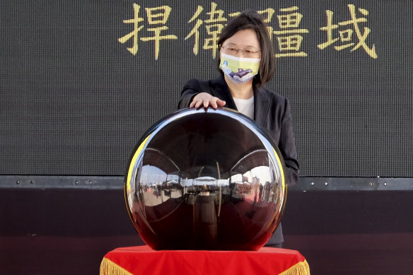 Taiwanese President Tsai Ing-wen touches a ceremonial orb to inaugurate the production of domestically-made submarines. The move marks a step forward for the island's defence strategy amid elevated tensions with China.