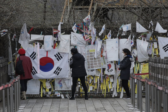 Business as usual. Visitors near the border between North and South Korea add to messages and flags of re-unification hope. There is still no official word on Kim's health.