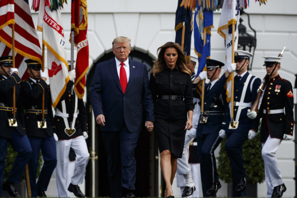 President Donald Trump and first lady Melania Trump arrive for a moment of silence at the White House.