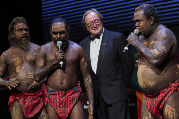 Former Essendon coach Kevin Sheedy with Tiwi Islands dancers, from left: Bon Gerard Timeapatua, Barry Ullungura jnr, and Joseph Pilakui.