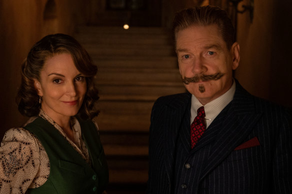 Tina Fey as Ariadne Oliver and Kenneth Branagh as Hercule Poirot in A Haunting in Venice.