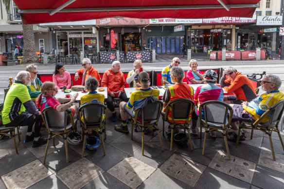 A group of cyclists enjoy coffee on Acland Street on Thursday.
