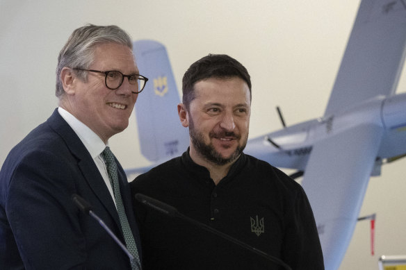 Prime Minister Keir Starmer, left, and Ukrainian President Volodymyr Zelensky smile as they stand in front one of the drones, built in Ukraine with funding from Britain, in Kyiv on Thursday.