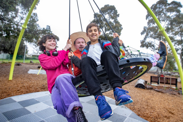 Artist Ian Pidd with Emily and Oscar practice at a park for the installation of Swing. 