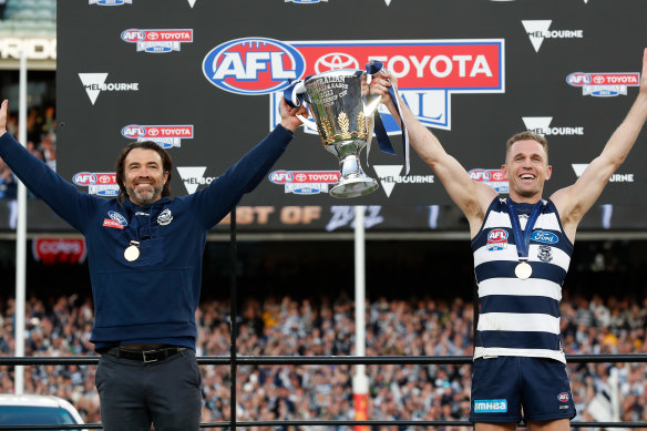 Chris Scott and Joel Selwood hold up the 2022 AFL premiership cup.