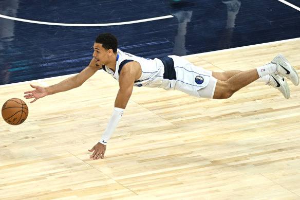 Josh Green dives for a loose ball last NBA season.