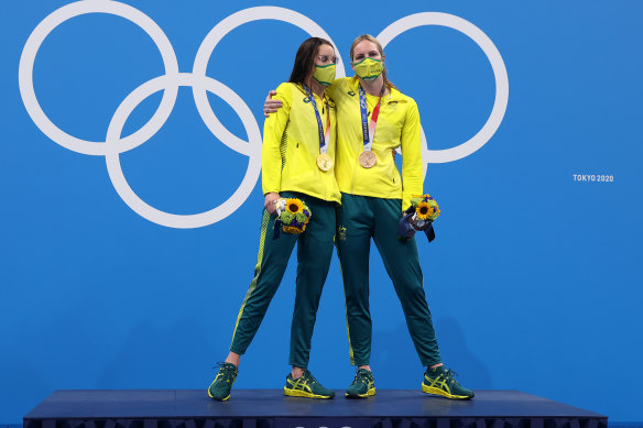 Kaylee McKeown and Emily Seebohm share the moment on the podium during the medal ceremony for the 200m backstroke final.