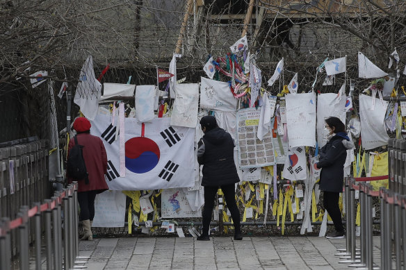Visitors near the border between North and South Korea add to messages and flags of reunification hope. 