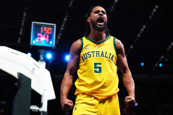 Hear me roar: Australia's Patty Mills celebrates making a basket against Team USA at Marvel Stadium on Saturday.