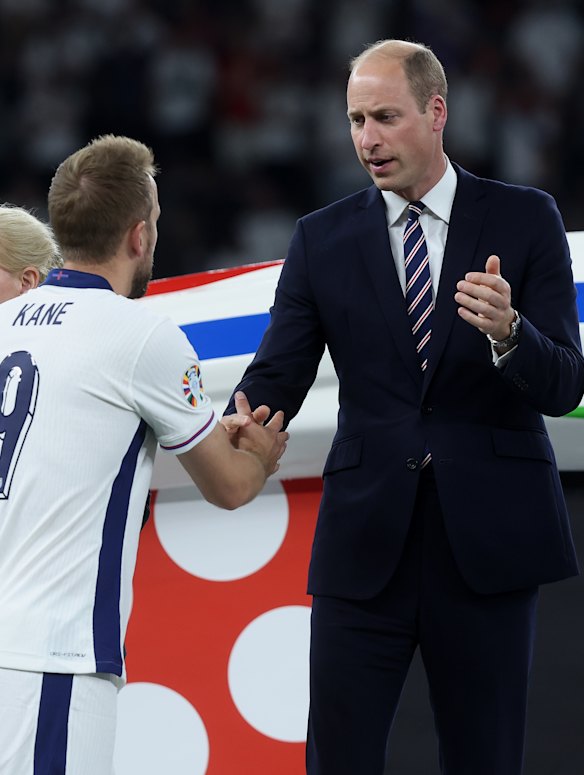 The Prince of Wales shakes hands with Harry Kane.