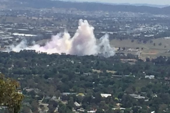 Seen from atop Mt Ainslie, Smoke billows out from the 2019 Summernats world simultaneous burnout 