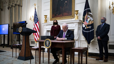 US President Joe Biden signs an executive order in the White House.
