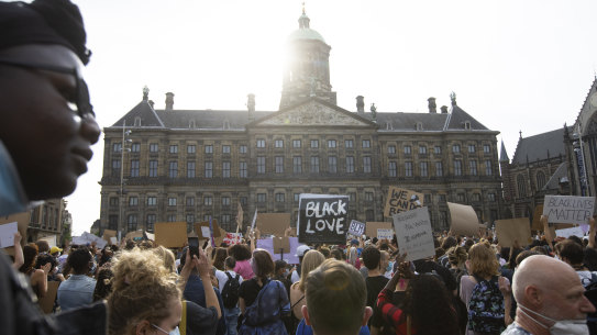 People take part in a Black Lives Matter protest in front of the Royal Palace on Dam Square in Amsterdam, Netherlands.
