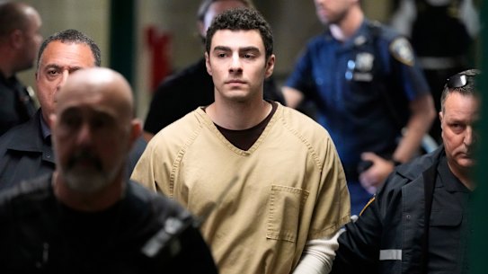 Luigi Mangione is escorted into Manhattan state court in New York on Tuesday.