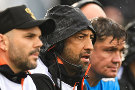 Wests Tigers coach Benji Marshall (second from left) on the bench in Tamworth.