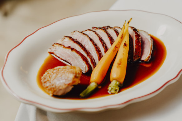 Slices of duck breast, with crisp skin and rosy meat, are lapped by an orange-scented glaze.