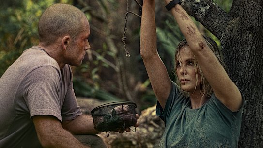 Taron Egerton as Ben, who turns hunter, with Charlize Theron as Sasha, his prey.