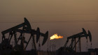 A flare burns as oil pump jacks operate in the Permian Basin, Texas. The American Sustainable Business Council is suing the Texas government for forcing it to invest in fossil fuels. 
