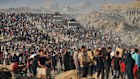Palestinians carry sacks and boxes of food and humanitarian aid, unloaded from a World Food Program convoy that was heading to Gaza City.