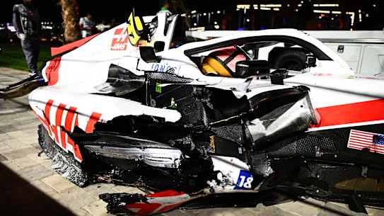 The wrecked car of Mick Schumacher on the side of the track after a crash.
