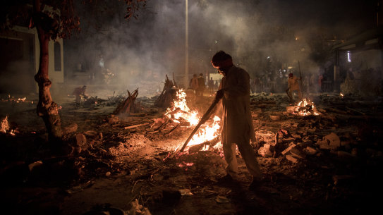 A crematorium in New Delhi on Thursday where multiple funeral pyres burn for victims of COVID-19.