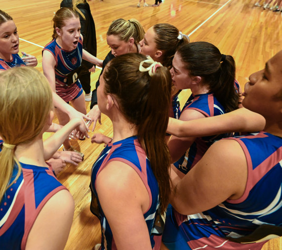 Westside Saints netballers in a huddle. Netball is Australia’s biggest participation sport for girls and women.