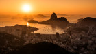 Sunrise over Guanabara Bay in Rio de Janeiro with Sugarloaf Mountain in the Horizon. It’s light very early at some times of the year.
