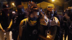 Protesters in Kenosha observe a moment of silence while marching near the scene of Tuesday night's fatal shooting.   
