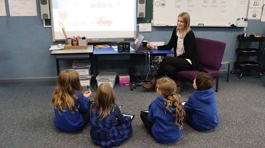 Teacher Maddison Flens with students at Tylden Primary School, which has transformed its approach to teaching reading.
