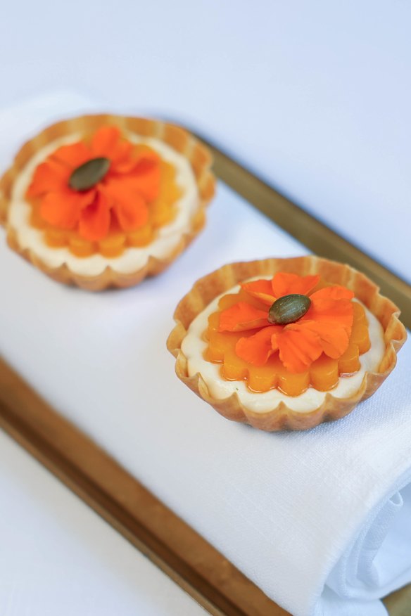 Tartelletta di zucca, a tartlet holding parmesan custard, confit pumpkin and pumpkin seed praline.