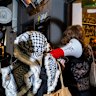 A group storms Miznon restaurant in Hardware Lane on Friday night.