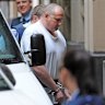 Leslie Alfred Camilleri is lead into the Supreme Court in Melbourne, Thursday, Dec. 5, 2013.