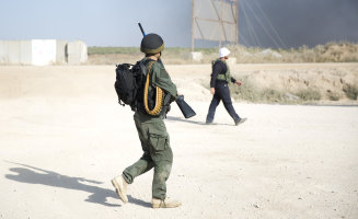 Israeli snipers walk at the Gaza border.