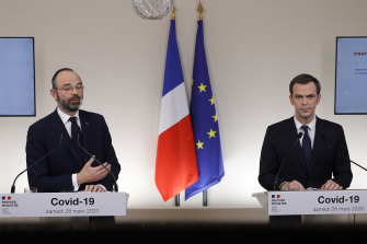 French Prime Minister Edouard Philippe, left, speaks with French Minister for Solidarity and Health Olivier Veran.