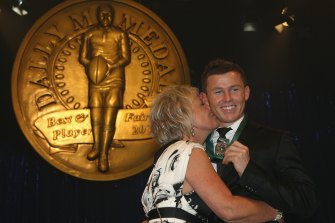 Todd Carney receives a kiss from his mother Leanne Carney as he poses with the Dally M Medal in 2010.