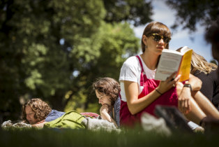 Molly George (right) enjoys some serious reading time in Carlton Gardens at the Silent Reading Party.