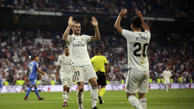 Fresh start: Real Madrid's Gareth Bale (left) celebrates with teammate Marco Asensio after scoring their side's second goal against Getafe.