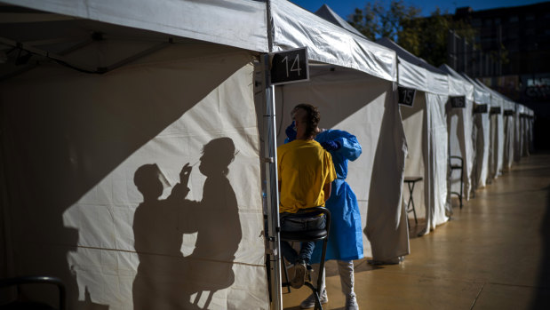 A volunteer takes a rapid antigen screening test in Barcelona in December.